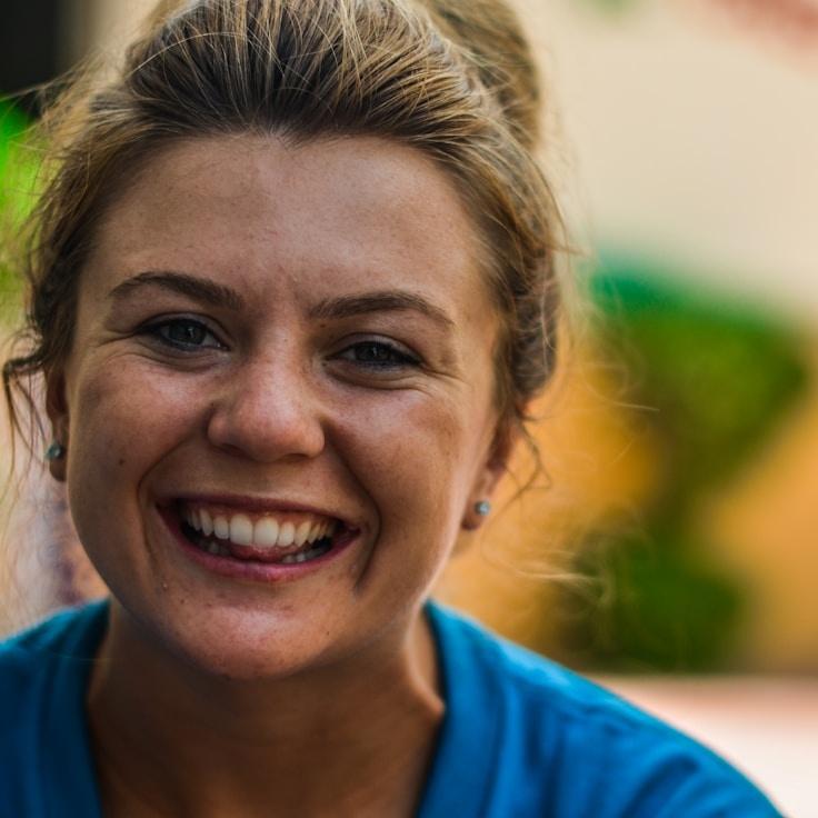 Kaveri Mehta, Lead Design Curator at Quiet Harbor Linen, reviewing corporate floral arrangements